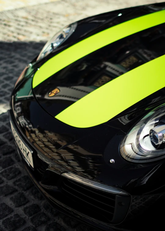 black and green porsche sports car parked on pavement