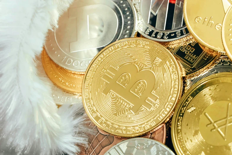 many bitcoins are sitting together, some gold and silver