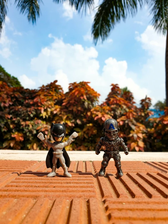 two toy soldiers in their military gear, each with a large helmet on