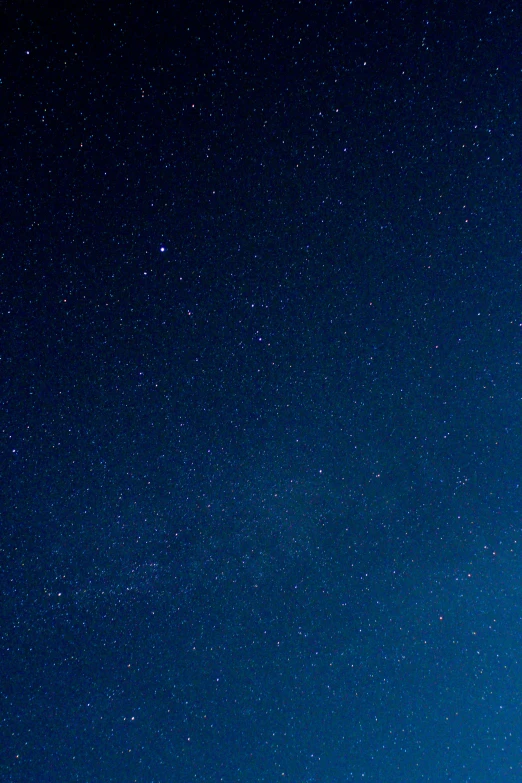 a long exposure of some stars above a forest