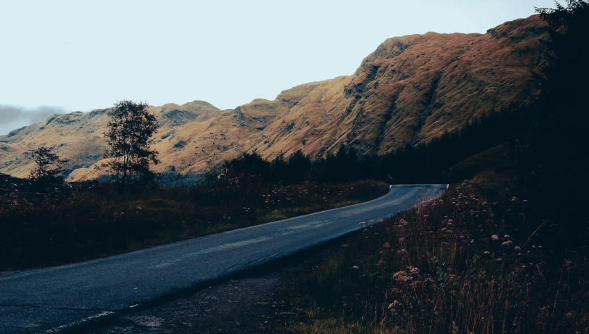 a scenic po of some mountains near a road