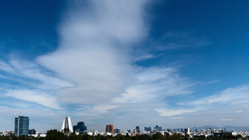 a long thin cloud hangs over a city