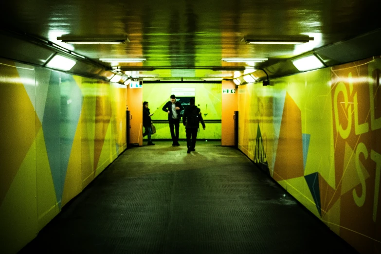 two people standing in an enclosed hallway