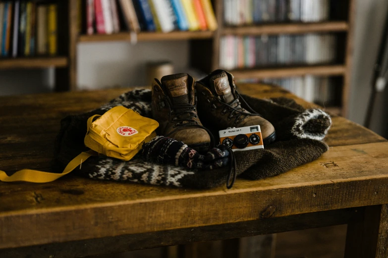 a purse on a table with some shoes and a backpack