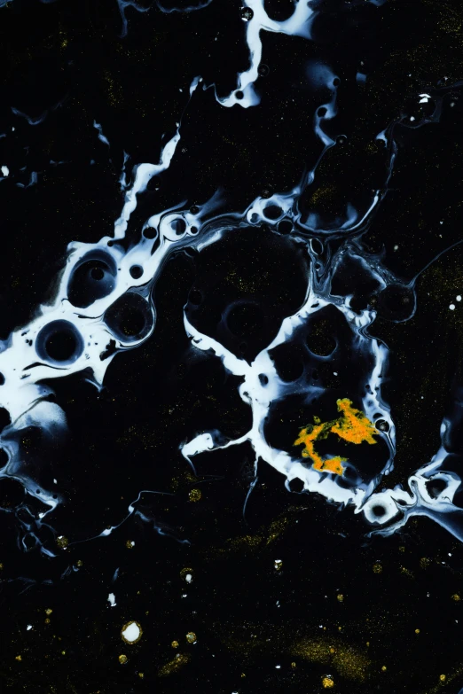 a yellow object is in the black liquid