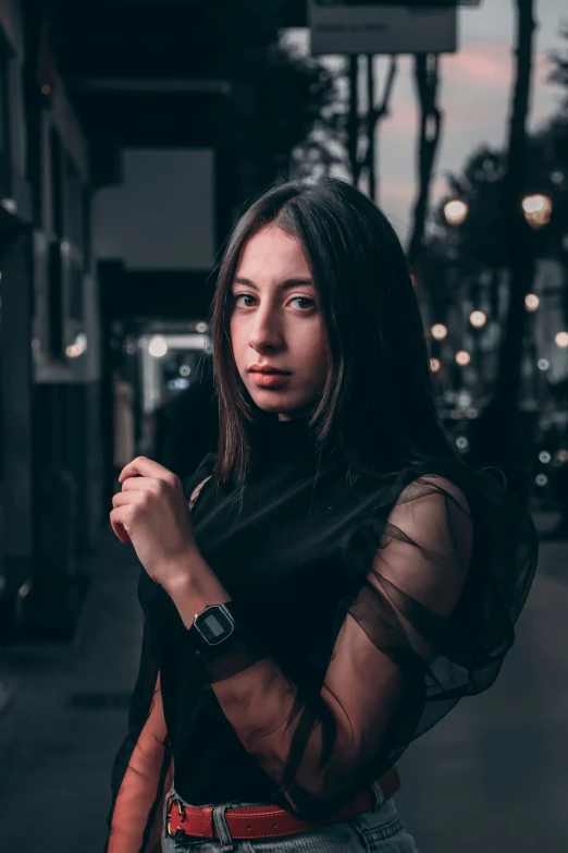 young woman standing on street posing for the camera