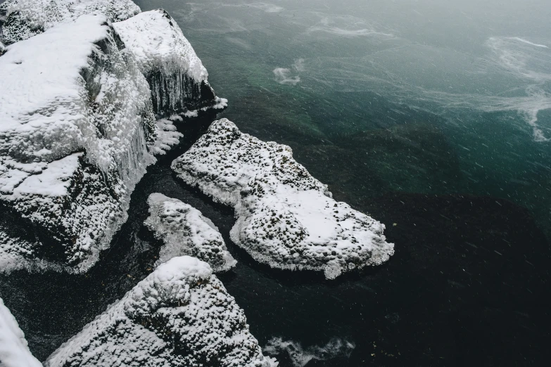 an icy landscape with some large rocks and ice