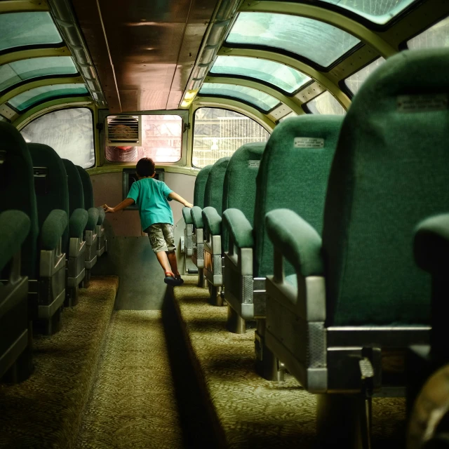 a  stands in the aisle of an old train