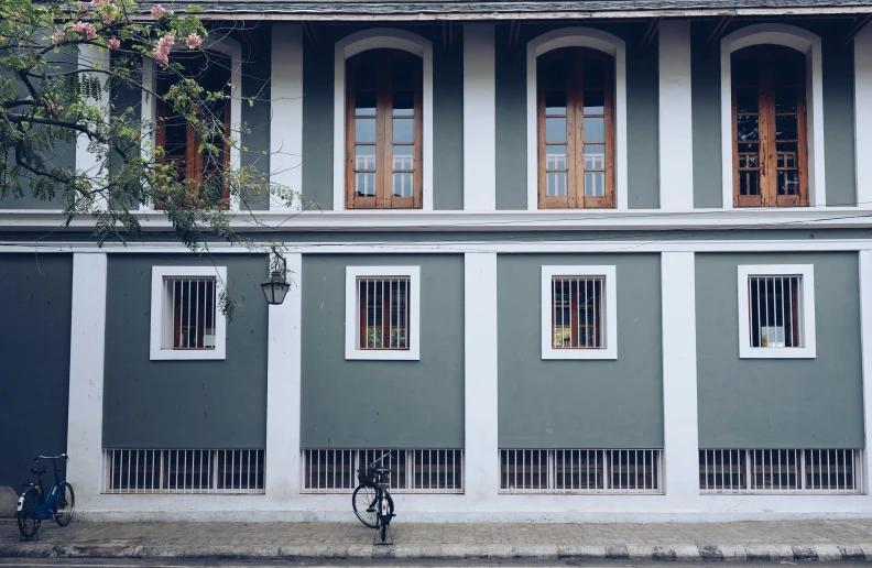 a grey building that has four windows and one door