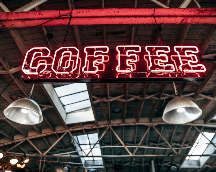 a restaurant sign that is neon lit above the ceiling