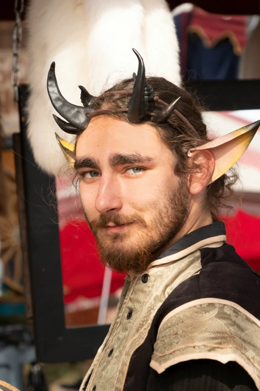 a man with horns and horned ears wearing a leather outfit