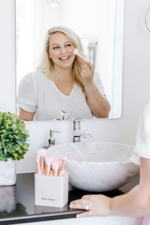 a woman standing in front of a mirror while brushing her teeth