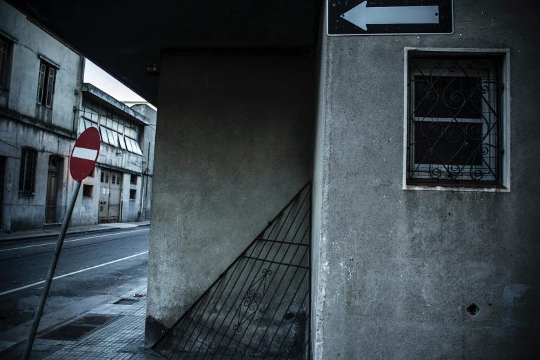 the corner with a red stop sign has been placed in front of a wall