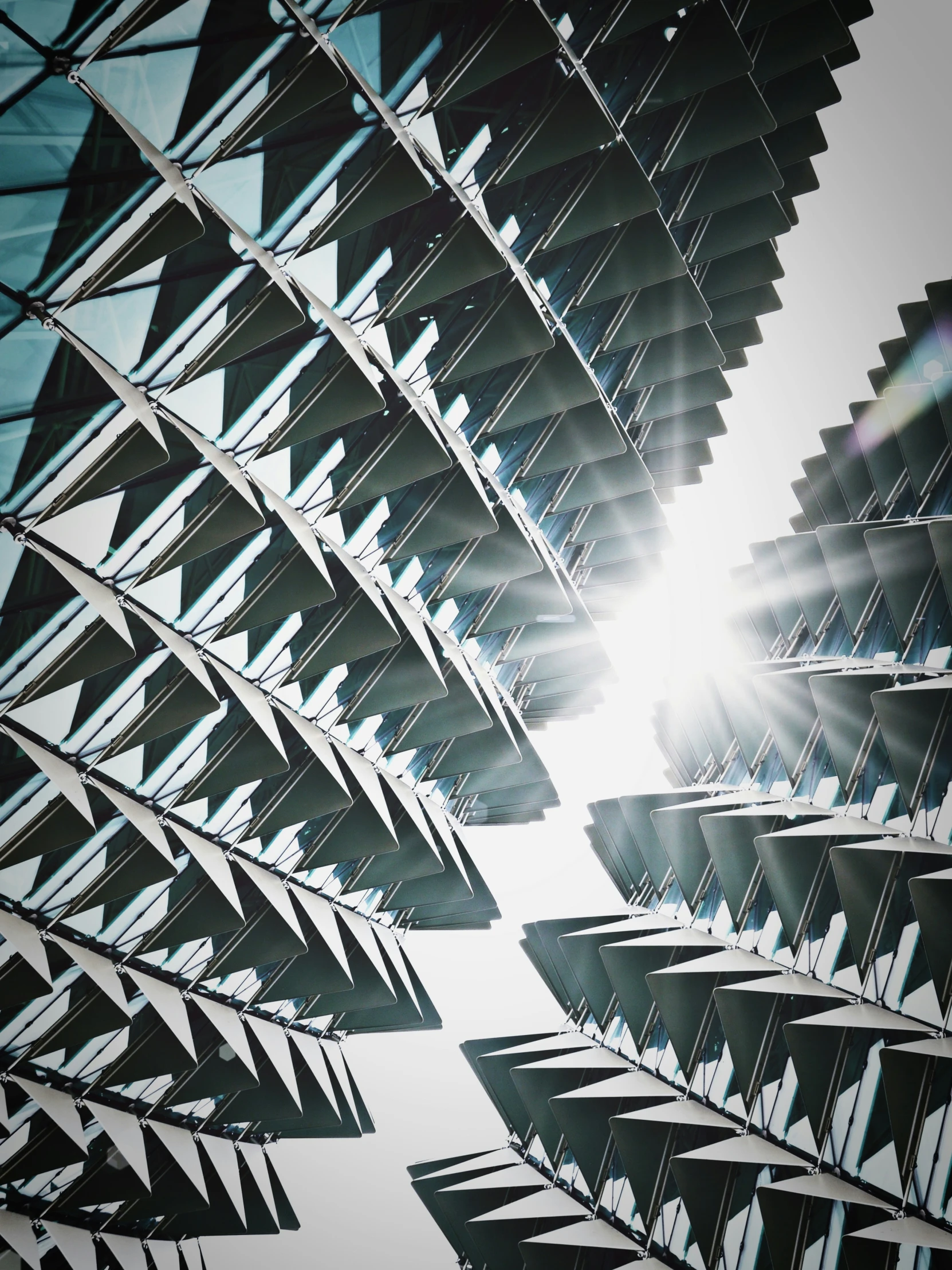 the sun behind the shades of a roof in a building