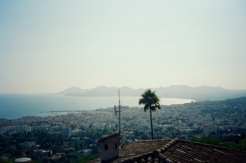 a view over the hills, with a house on the top