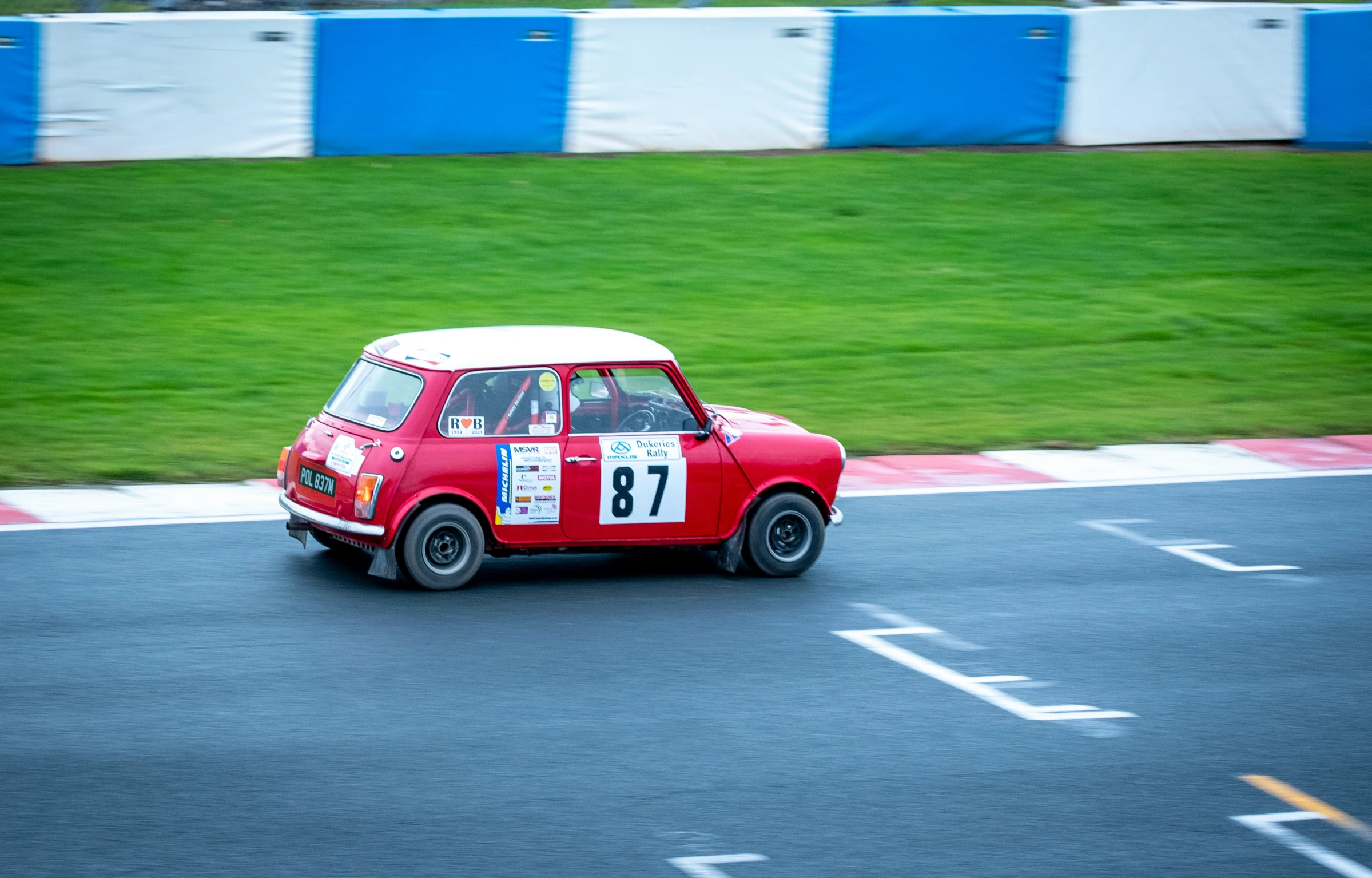 an old time mini driving down the road