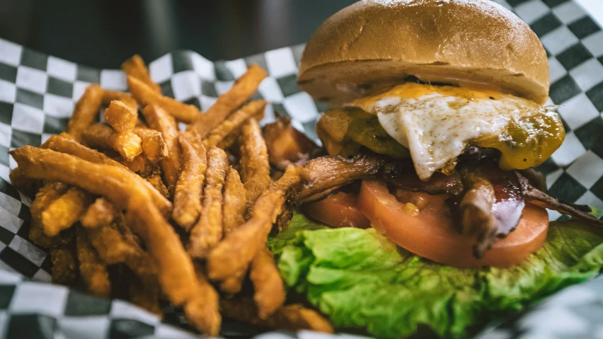 hamburger and fries in baskets sitting on a table