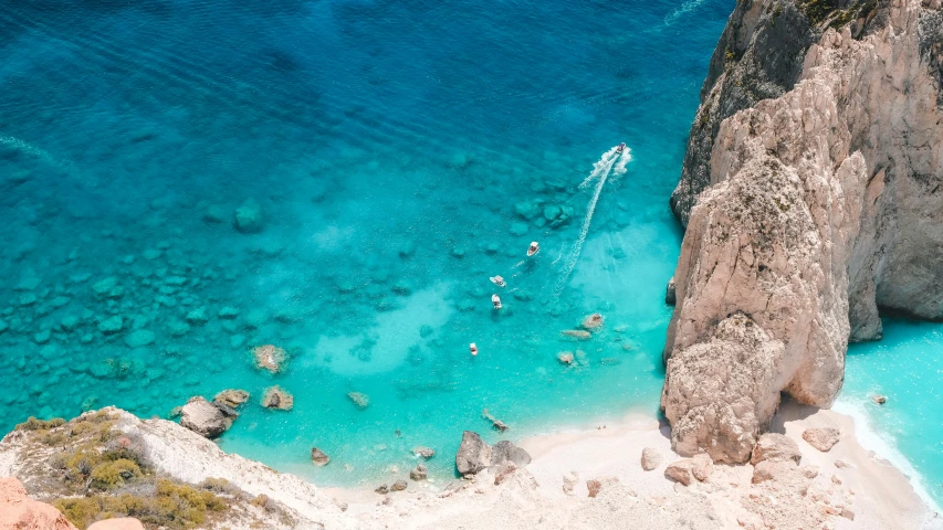 some people riding boats in the blue water