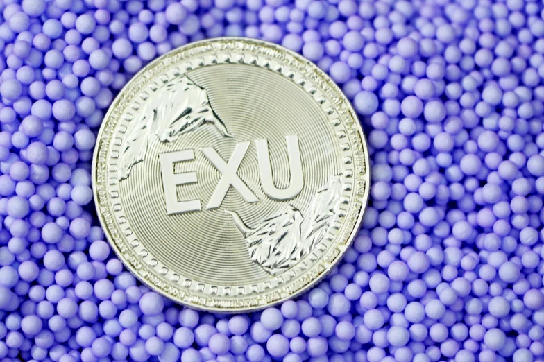 a close - up image of an exu token surrounded by blue balls