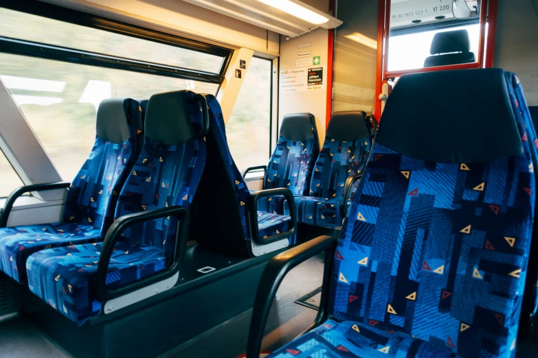 two seats and an open window on a bus