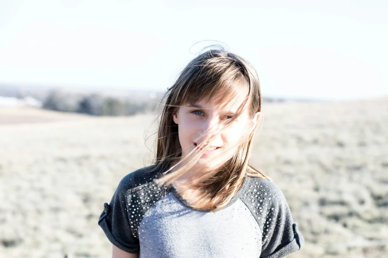 a  stands in an empty grass covered field