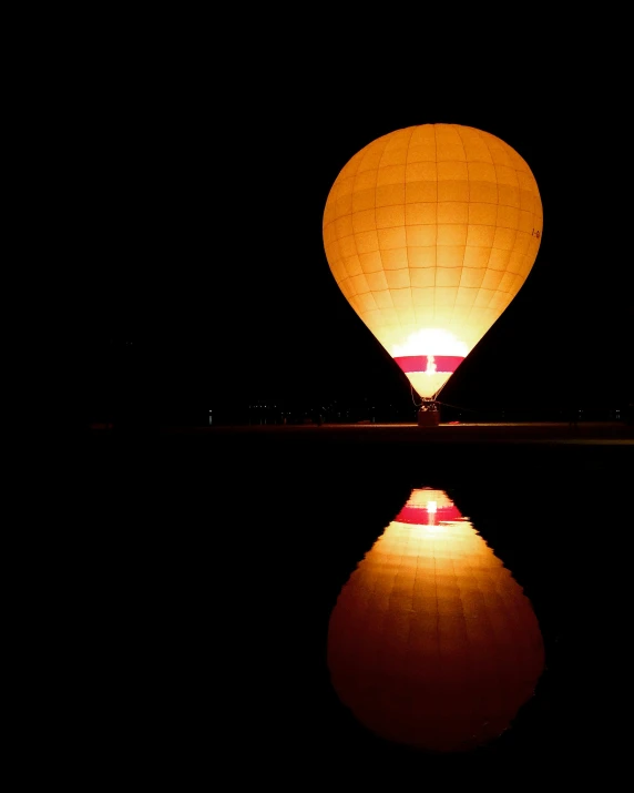 a po taken at night looking at a light up balloon in the air