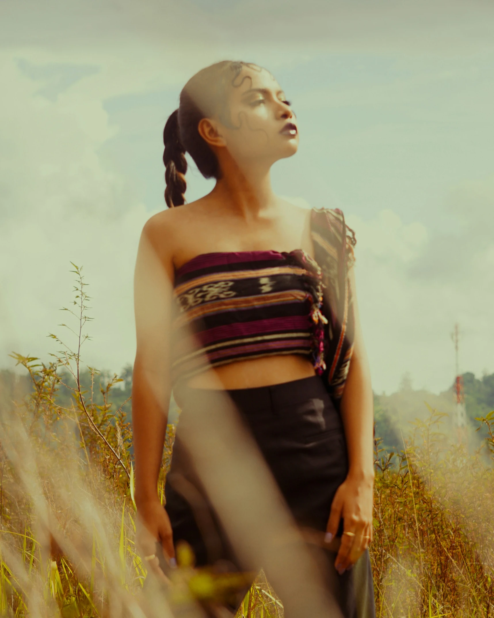 woman with id standing in tall grass, outdoor