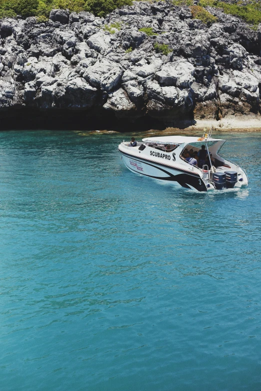 a small boat is sailing across the clear water