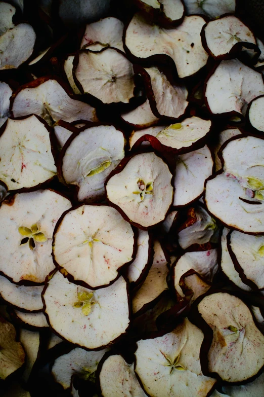 a group of white apple halves with brown and green spots