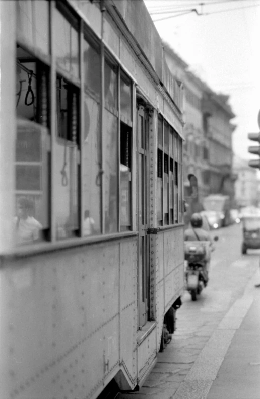 black and white image of a train on a street