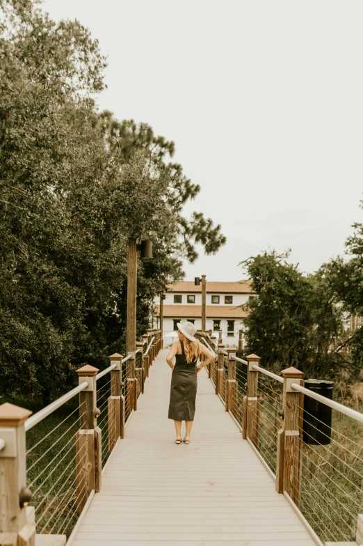 there is a woman that is walking across the bridge