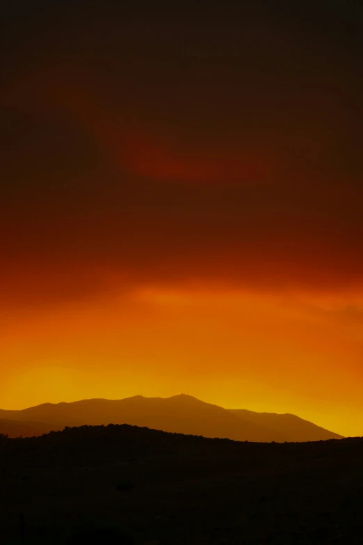 there are a few clouds above the mountains