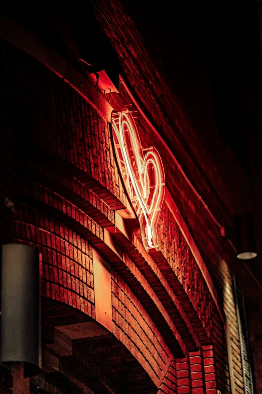 an illuminated brick wall with a red heart