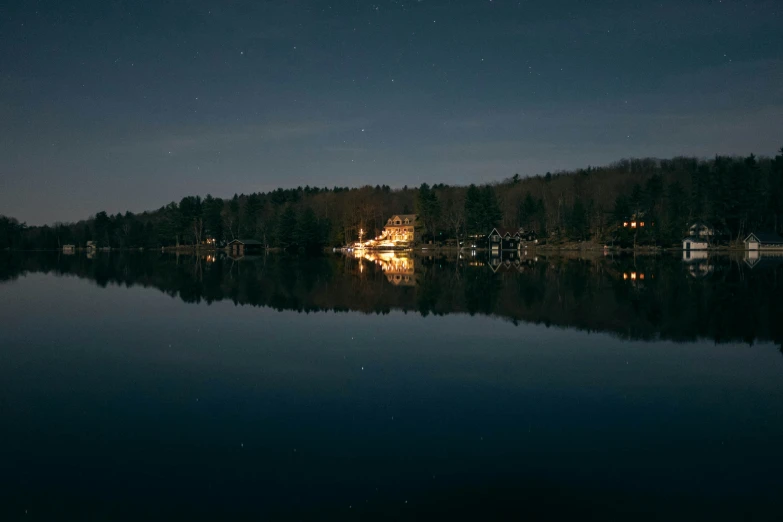 houses on the side of a lake at night