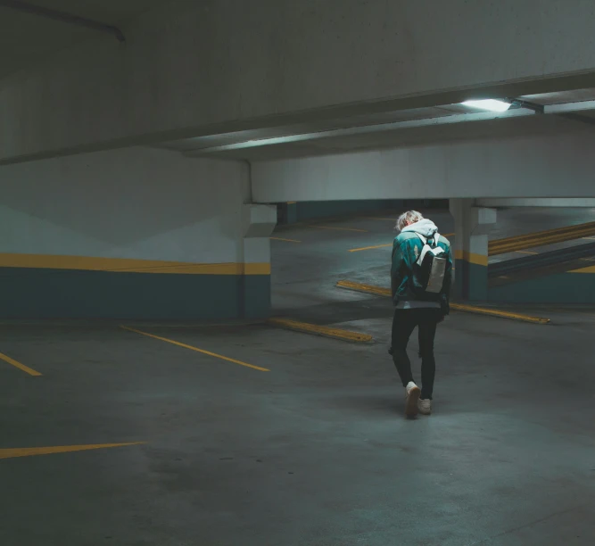 a person in a parking garage holding onto another persons backpack