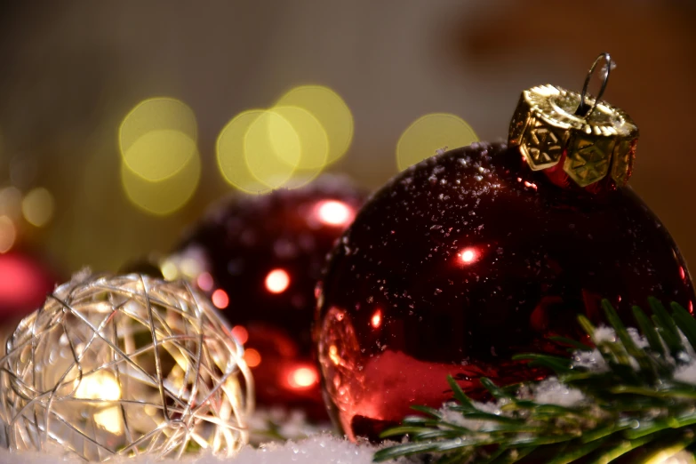 a red christmas ornament is displayed near some holiday decorations