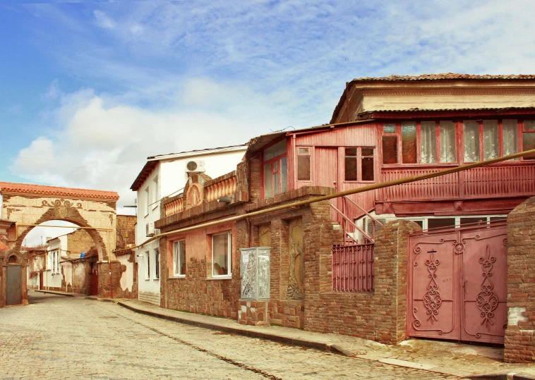 two old buildings on an alley way surrounded by bricks