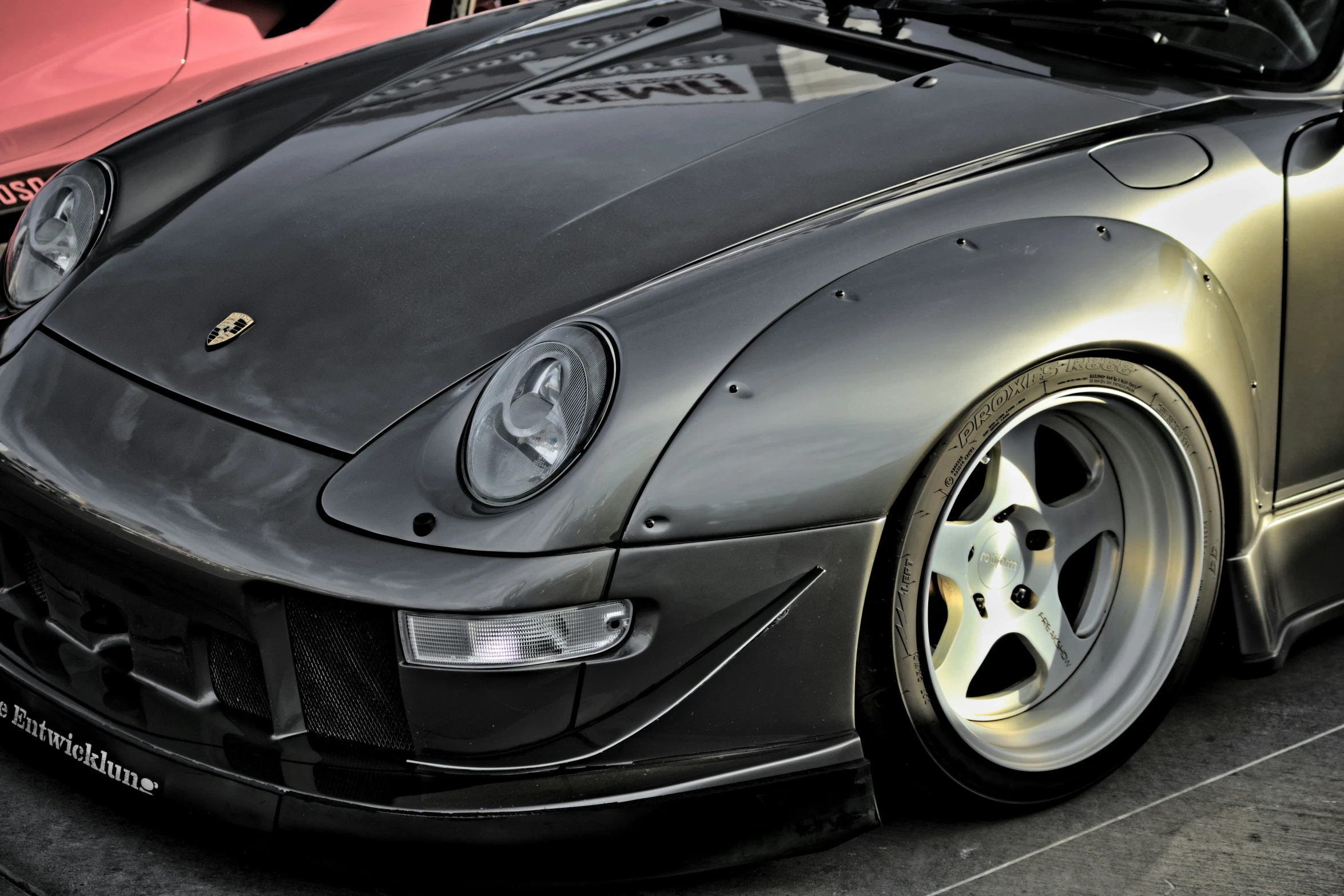 a black and grey car with hood open