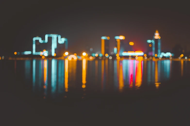 a lake that has some water and buildings in the background