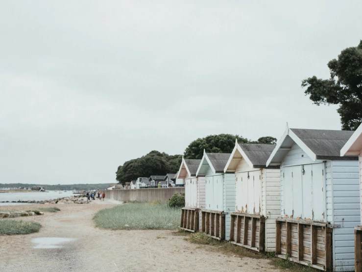 a beach hut's sitting on the sand beside a river