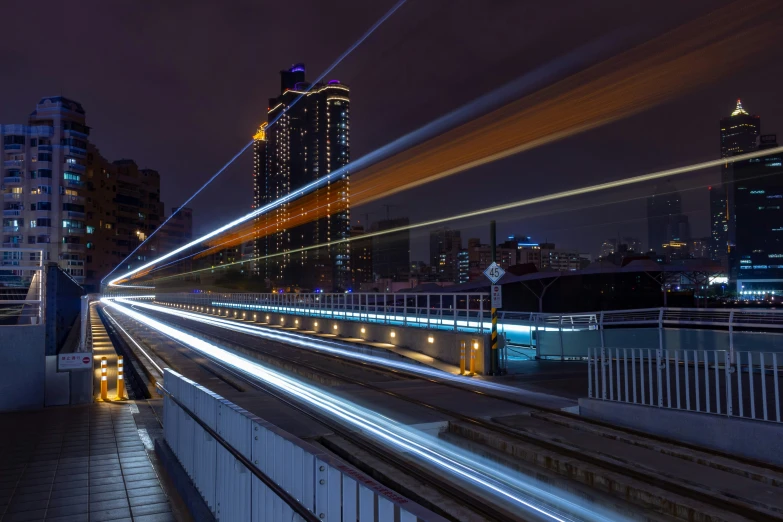 a very long exposure of a city from bridge over rail tracks