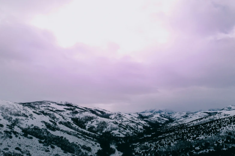 a bunch of mountains are covered in snow