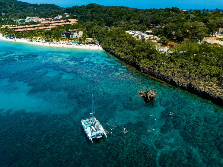 some boats that are in the water next to an island