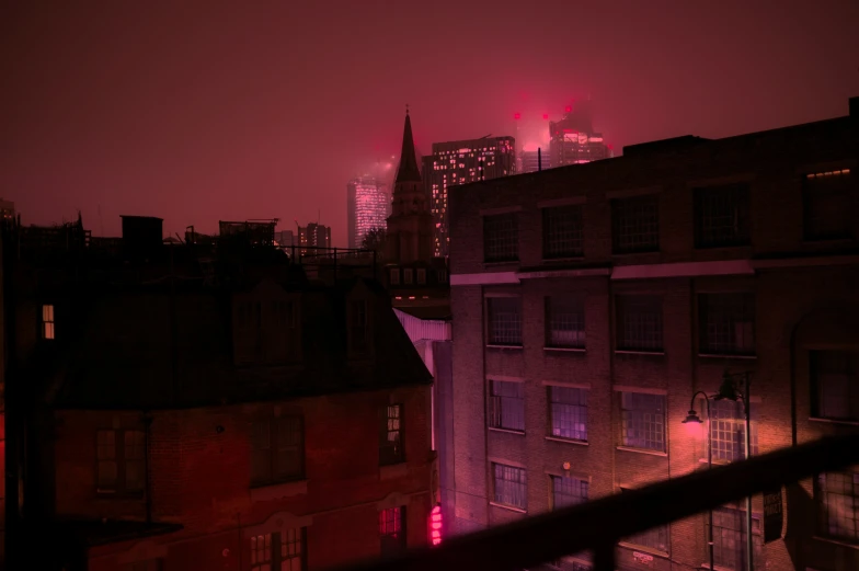 red and purple lights shining off the windows in a building