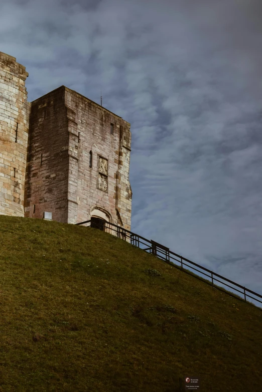 the old tower building is near the top of a hill