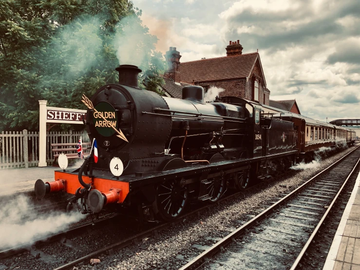 a steam engine on a train track in a rail yard