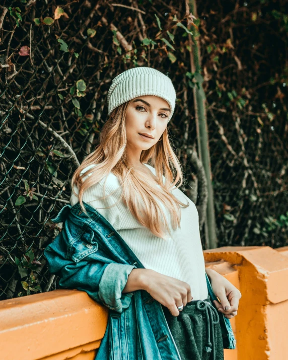 a woman wearing a winter hat standing outside