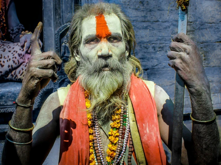 a man in orange shirt and white face paint