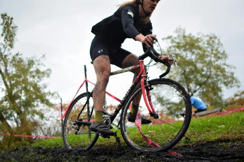 a man riding a bike through the mud