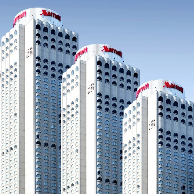 a row of white high rise buildings with an advertit on them